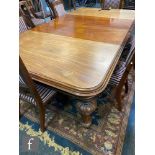 A Victorian mahogany wind-out extending dining table of rectangular form with three additional