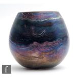 A later 20th Century glass vase of swollen ovoid form, the purple iridescent ground with wavy