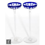 A pair of Baccarat Tzar champagne coupes, the bowl cased in cobalt blue and cut with a stylised