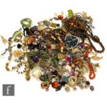 A parcel lot of assorted costume jewellery to include beads, brooches, earrings, pendants,