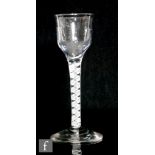 An 18th Century drinking glass circa 1765, the fluted ogee bowl above double series opaque twist