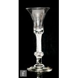 An 18th Century composite stem drinking glass circa 1750, the drawn trumpet bowl with a multi series