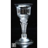 An 18th Century champagne or sweetmeat glass circa 1745, the ogee bowl with everted rim over a