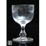 An 18th Century drinking glass circa 1790, the cup form bowl over a true baluster stem and raised to