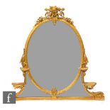 A 19th Century gilt over mantle mirror, the oval plate surmounted with a bird above four platform