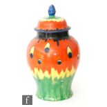 A 1930s Art Deco Crown Ducal ovoid vase and cover decorated with hand painted red to yellow to green