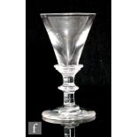 An 18th Century dram glass circa 1800, the deceptive trumpet bowl above three ringed collar neck