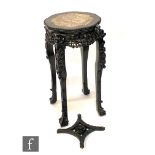 An early 20th Century Chinese hardwood jardiniere stand with inset rouge marble top, the foliate