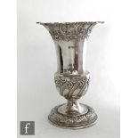A hallmarked silver squat trumpet vase with foliate embossed decoration to foot rim and crimped
