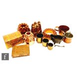 A copper castellated jelly mould, a copper ring jelly mould, two other moulds, a copper brass