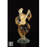 An Italian Murano glass figure of a musician playing a lute, with amethyst core and gold