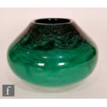 A later 20th Century Strathearn squat form glass vase, the swirling green glass with aventurine