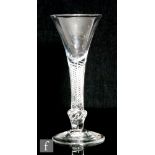 An 18th Century composite stem drinking glass circa 1750, drawn trumpet bowl over a multi series air