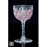 A late 19th Century Richardsons wine glass, the ovoid bowl with applied ruby threading and cut