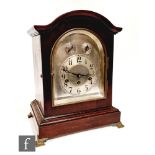 An Edwardian mahogany cased bracket clock with silvered arch dial incorporating Slow/Fast and