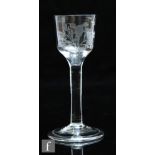 An 18th Century wine glass circa 1750, the ogee bowl engraved with a bird and flowers above a