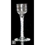 An 18th Century drinking glass circa 1765, the ogee bowl above a double series opaque stem with