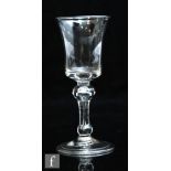 An 18th Century wine glass circa 1750, the waisted bucket bowl over an inverted baluster stem with