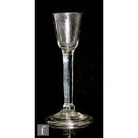 An 18th Century drinking glass circa 1750, the round funnel bowl above a solid plain basal knopped