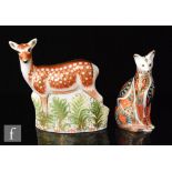 Two boxed Royal Crown Derby paperweights comprising a Fallow Deer and a Siamese cat, both with
