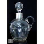An early 20th Century Stourbridge glass and hallmarked silver spirit decanter, the ribbed ovoid body