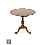 A late 20th Century reproduction mahogany snap top supper table with bird cage action, the