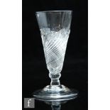 An 18th Century dwarf ale glass circa 1700, the moulded funnel bowl with wrythen decoration with a