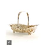 A hallmarked silver cushioned rectangular swing basket with part embossed decoration below crimped