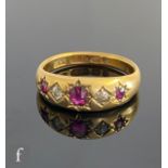 An 18ct hallmarked five stone ruby and diamond gypsy set ring, alternating stones to plain