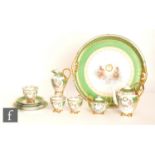 A 20th Century continental tete-a-tete set comprising coffee pot, three cups and saucers, one side