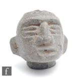 A Costa Rican Pre-Columbian stone head fragment, the grey stone loosely carved with deep carved