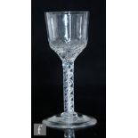 An 18th Century drinking glass circa 1750, the ogee form bowl with basal lattice moulding above a