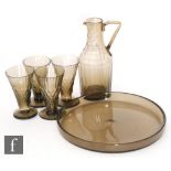 A 1930s French Art Deco drinks set by Daum comprising a slice and facet cut flask with angular