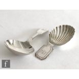 Two hallmarked silver caddy spoons one with shell bowl and bright cut details, the other plain