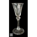 An 18th Century wine glass circa 1750, the pointed round funnel bowl above a balustroid stem with