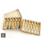 Two boxed sets of six Norwegian silver gilt tea spoons each with enamelled decoration to handles,