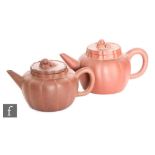 A pair of late Qing (1644-1912)/ Republic (1912-1949) Chinese red stoneware Yixing teapots, to