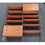 A 1960s teak Ladderax two bay modular bookcase system on steel supports, designed by Robert Heal for