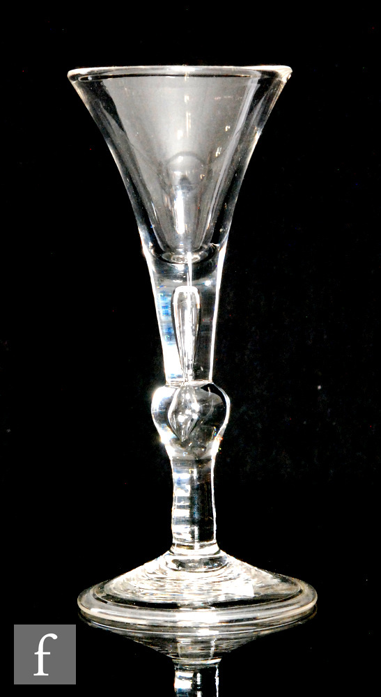 An 18th Century baluster Kit Kat type drinking glass, circa 1730, the trumpet bowl above a plain