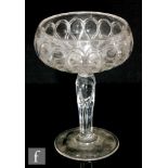 A large early 20th Century Stourbridge glass pedestal bowl with a repeat loop design to the bowl and