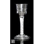 An 18th Century drinking glass circa 1760, the stepped 'Lynn' ogee bowl above double series opaque