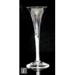 An 18th Century toasting glass circa 1760, the trumpet bowl above a double series opaque twist