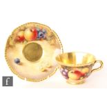 A later 20th Century matched Royal Worcester Fallen Fruits teacup and saucer, the teacup decorated