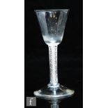 An 18th Century drinking glass circa 1765, the round funnel bowl above a double series opaque