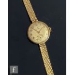 A 9ct lady's Cyma manual wind wrist watch, Arabic numerals to a circular dial, case diameter 22mm,