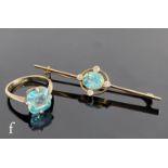 An early 20th Century 9ct blue zircon and diamond bar brooch, central millgrain set zircon within