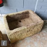 A sandstone trough of rectangular form with a drilled hole to the base, height 31cm, width 62cm