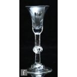 An 18th Century wine glass circa 1730, the bell bowl with solid base above a balustroid stem with