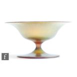 A small early 20th Century Steuben glass pedestal dish decorated in Gold Aurene with an onion skin