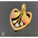 An Edwardian 15ct open work heart shaped pendant with three central freshwater pearls flanked by